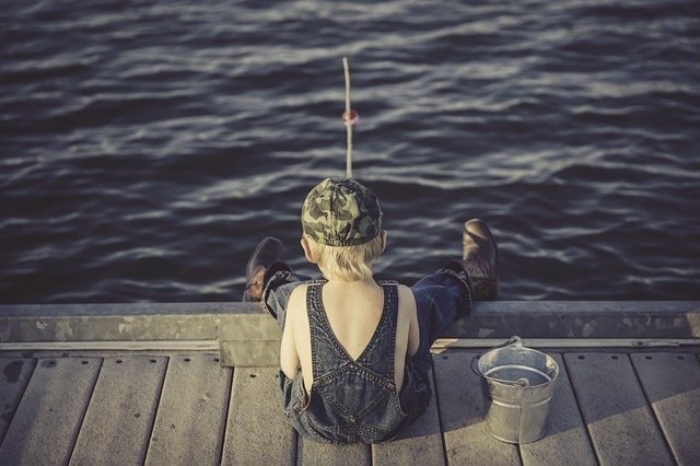 A boy fishing on a dock